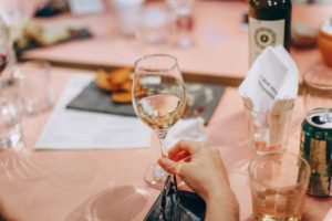 glass being held over a table top