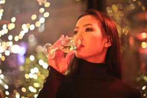 Asianwoman drinking glass if wine